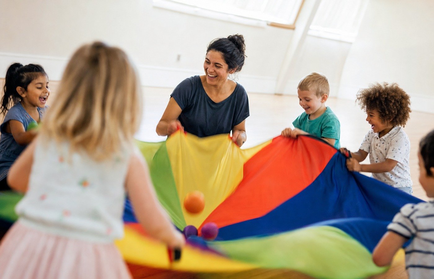 Preschoolers and a teacher playing a parachute group game